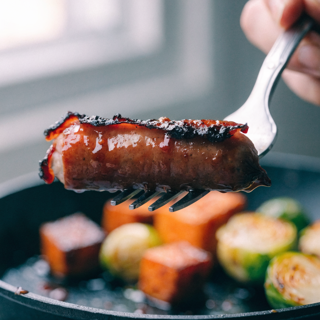 Close-up of sheet-pan turkey sausage with fall vegetables and maple-dijon glaze